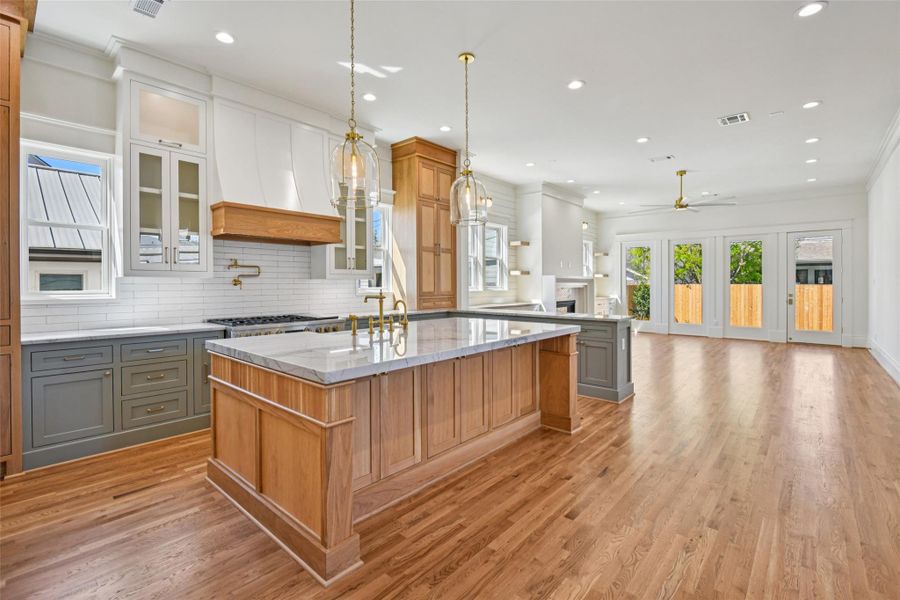 The kitchen transitions well into the main living room. Island features Hudson Valley lighting above and a stunning reeded white oak design on the lower island. The kitchen transitions well into the main living room. Island features Hudson Valley lighting above and a stunning reeded white oak design on the lower island.