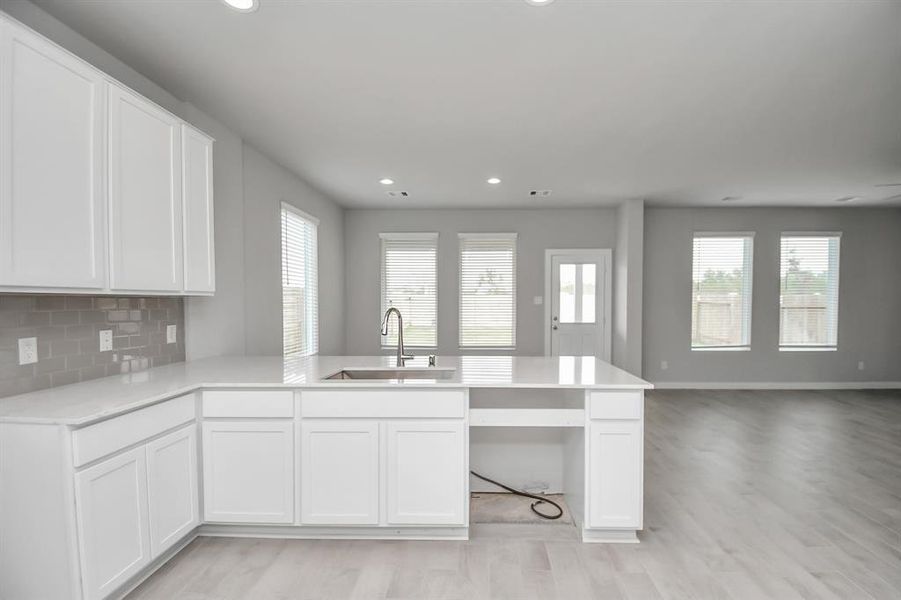 The open concept effortlessly connects the kitchen to the expansive family room, forming a perfect hub for gatherings. This seamless flow creates an inviting space where cooking and socializing come together harmoniously.