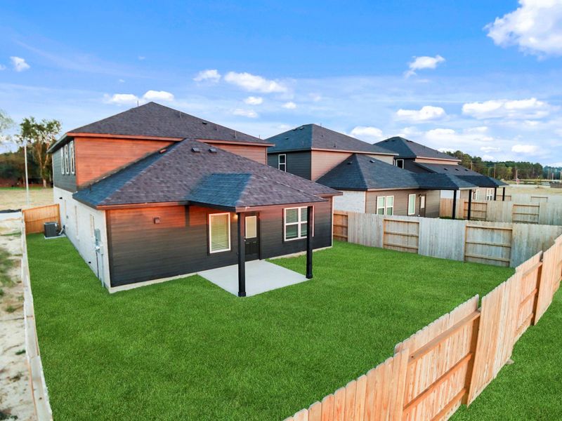 Another angle of the backyard highlights the covered patio and privacy fence that frames the perfect setting for gatherings or weekend barbecues with family and friends.