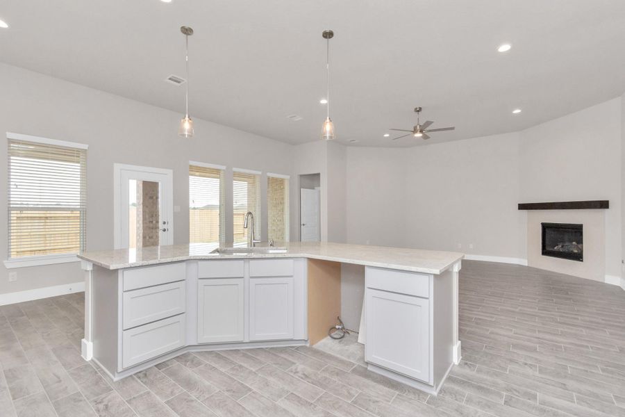 All of this overlooks your expansive family room, creating a perfect space for culinary delights and family gatherings. Sample photo of completed home with similar floor plan. Actual colors and selections may vary. All of this overlooks your expansive family room, creating a perfect space for culinary delights and family gatherings. Sample photo of completed home with similar floor plan. Actual colors and selections may vary.