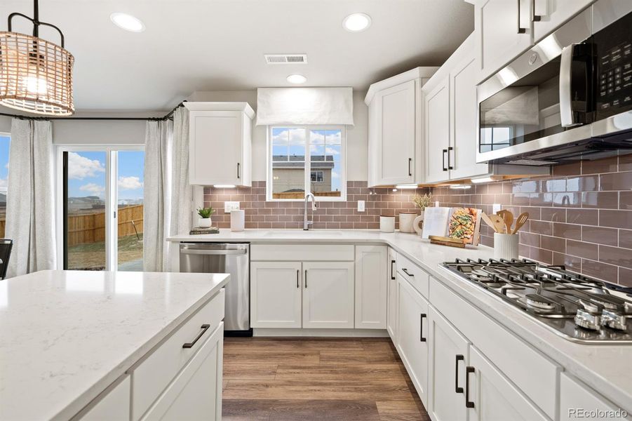 Photos shown are of a previously built model home and are intended to represent the floor plan. The home currently available may include different finishes, features, and selections.