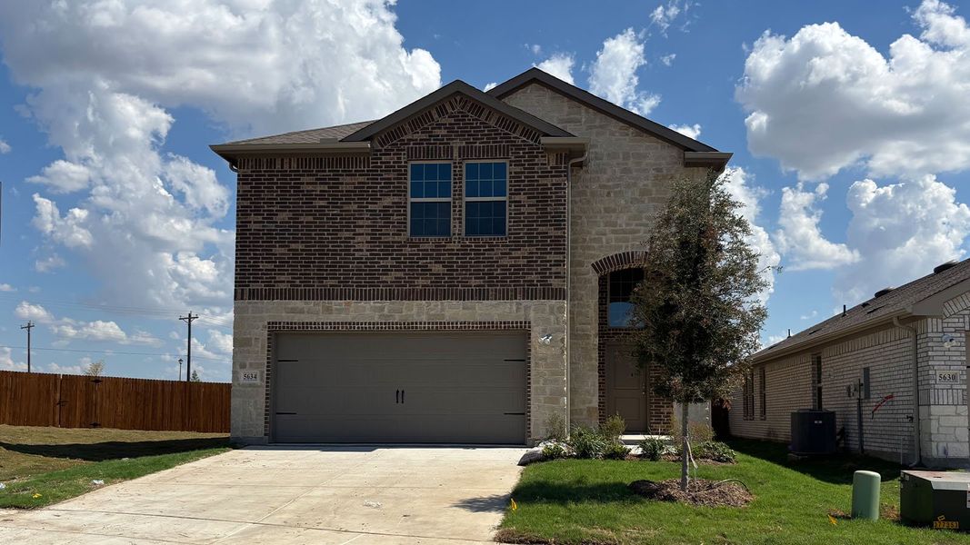 Front exterior of a new home in Wildcat Ranch, Crandall, TX, highlighting curb appeal (Image 1). Front exterior of a new home in Wildcat Ranch, Crandall, TX, highlighting curb appeal (Image 1).