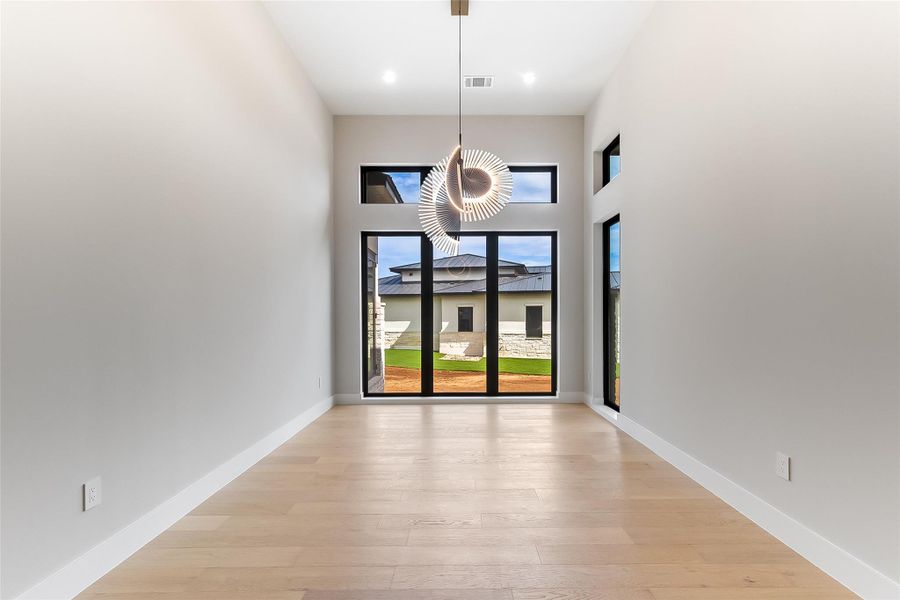Unfurnished dining area with light wood-style flooring and baseboards Unfurnished dining area with light wood-style flooring and baseboards