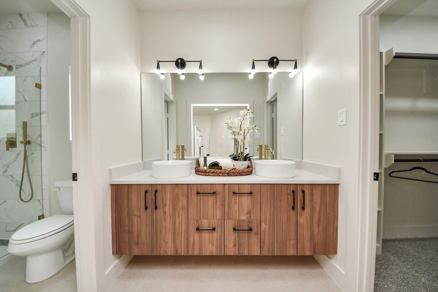 Sophisticated double vanity with quartz countertops and ample storage.