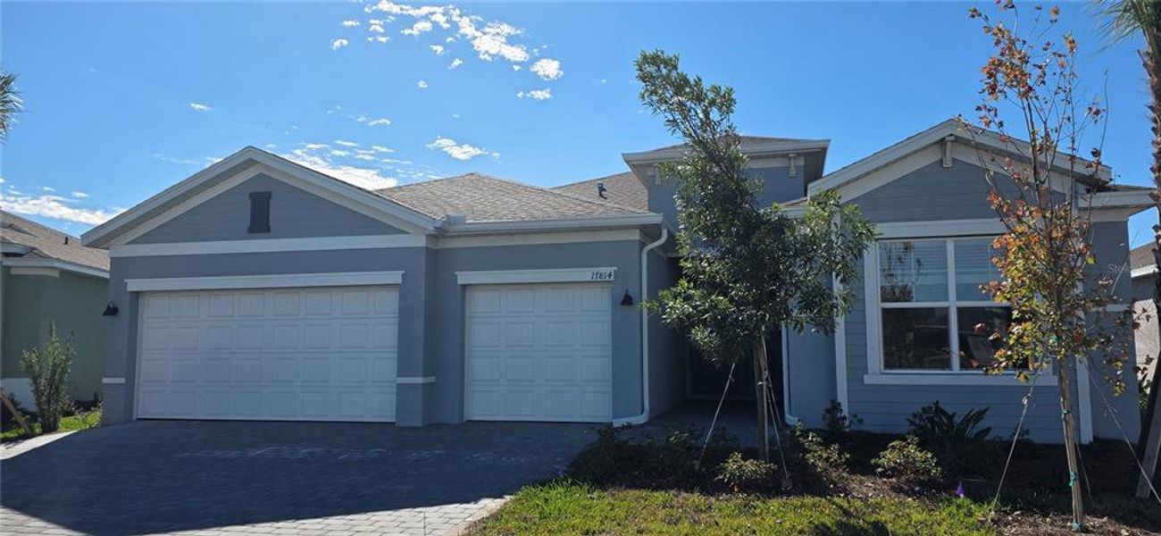 Front exterior of a new home in Rye Ranch, Parrish, FL, highlighting curb appeal (Image 1). Front exterior of a new home in Rye Ranch, Parrish, FL, highlighting curb appeal (Image 1).