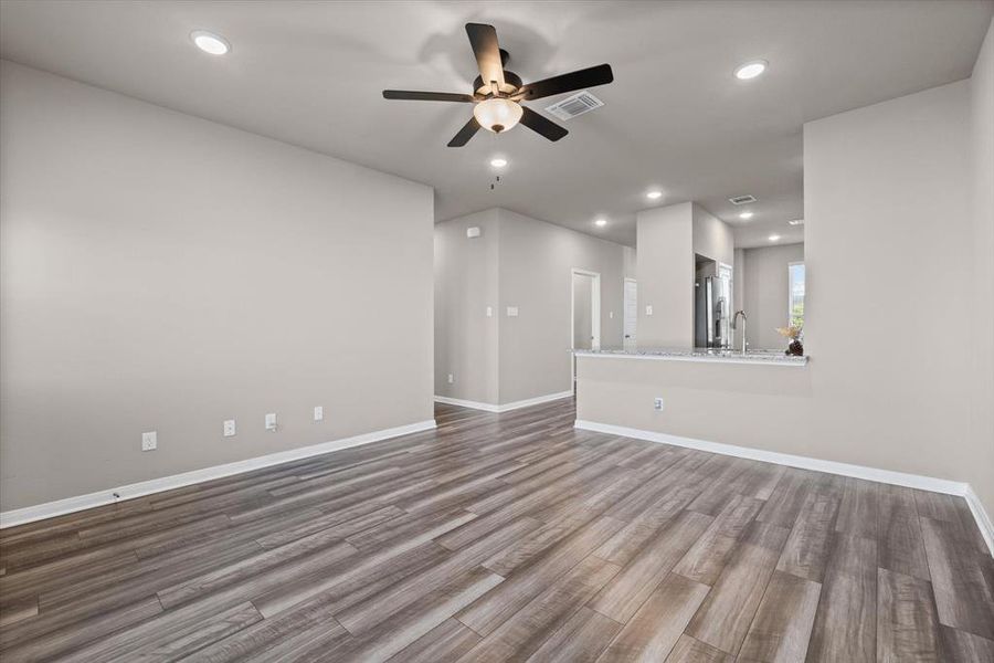 Unfurnished living room featuring recessed lighting, light wood finished floors, and a ceiling fan Unfurnished living room featuring recessed lighting, light wood finished floors, and a ceiling fan