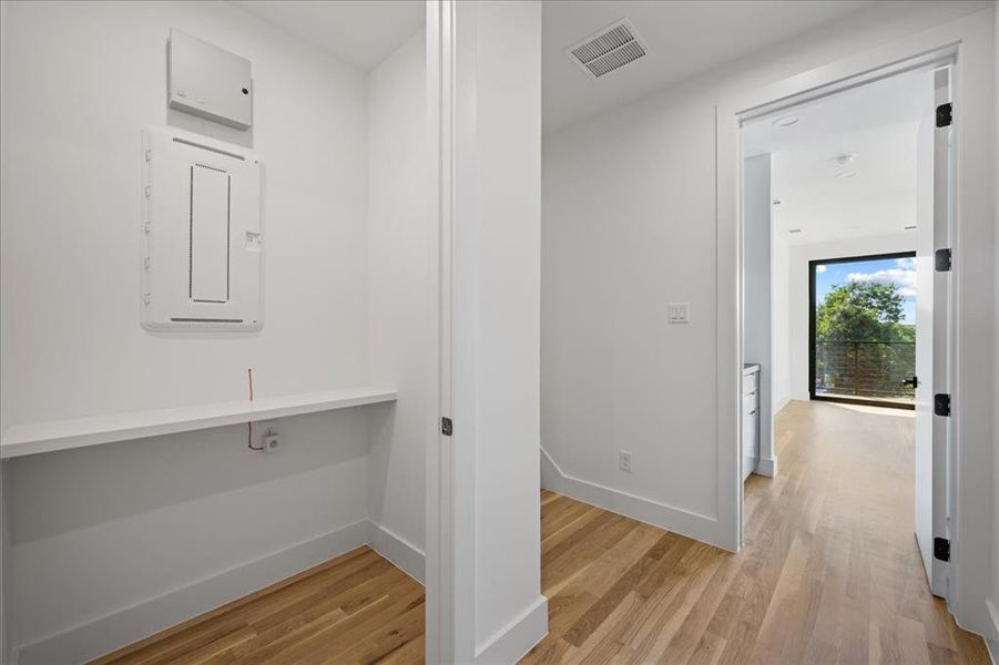 Hallway leading to Primary bedroom. Large hall closet, high baseboards and light wood finished floors Hallway leading to Primary bedroom. Large hall closet, high baseboards and light wood finished floors