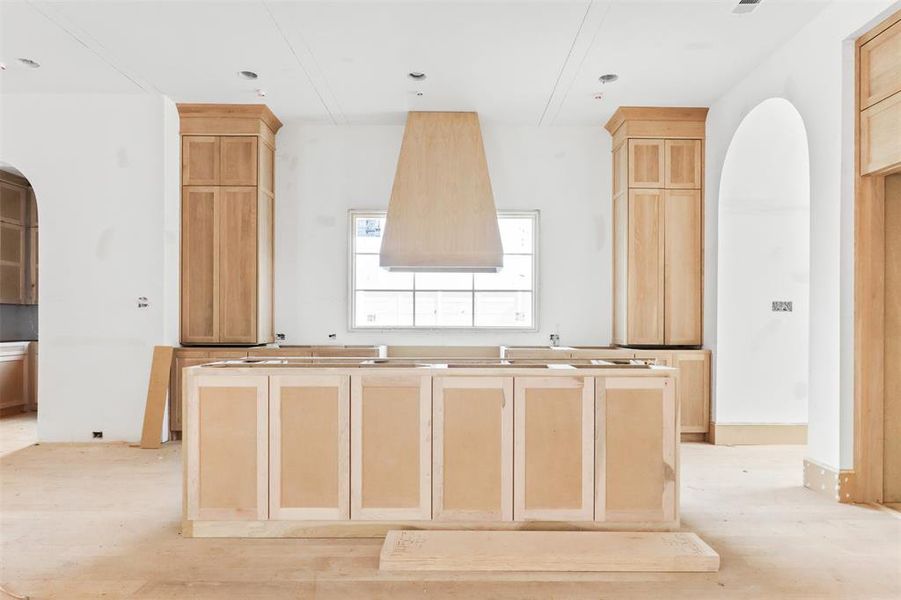 Kitchen with light wood-type flooring and light brown cabinets