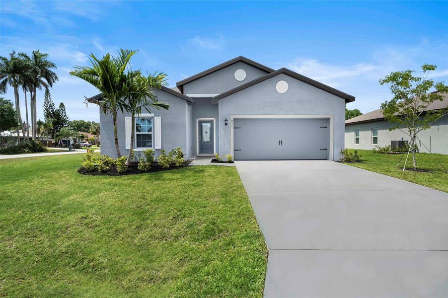 Front exterior of a new home in Port St Lucie, Port St. Lucie, FL, highlighting curb appeal (Image 12).