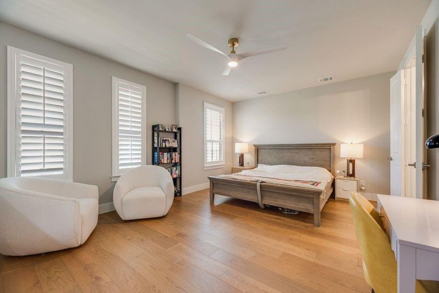 Bedroom with light wood finished floors and ceiling fan
