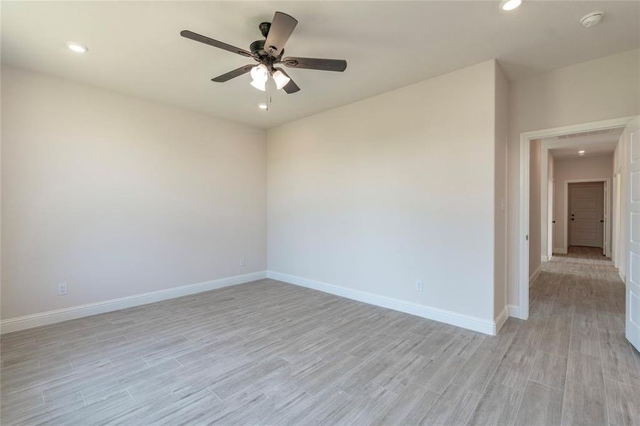 Spare room with ceiling fan and light hardwood / wood-style flooring