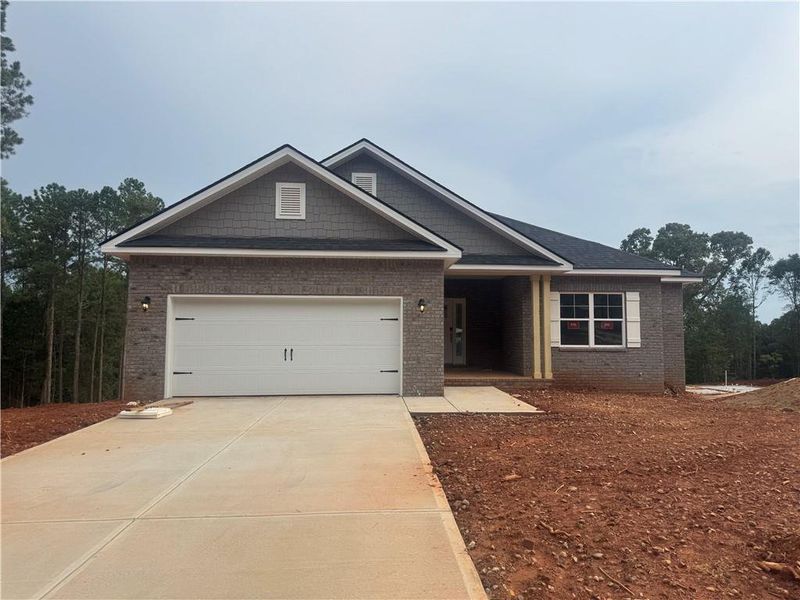 Front exterior of a new home in The Fields of Walnut Creek, Pendergrass, GA, highlighting curb appeal (Image 2). Front exterior of a new home in The Fields of Walnut Creek, Pendergrass, GA, highlighting curb appeal (Image 2).