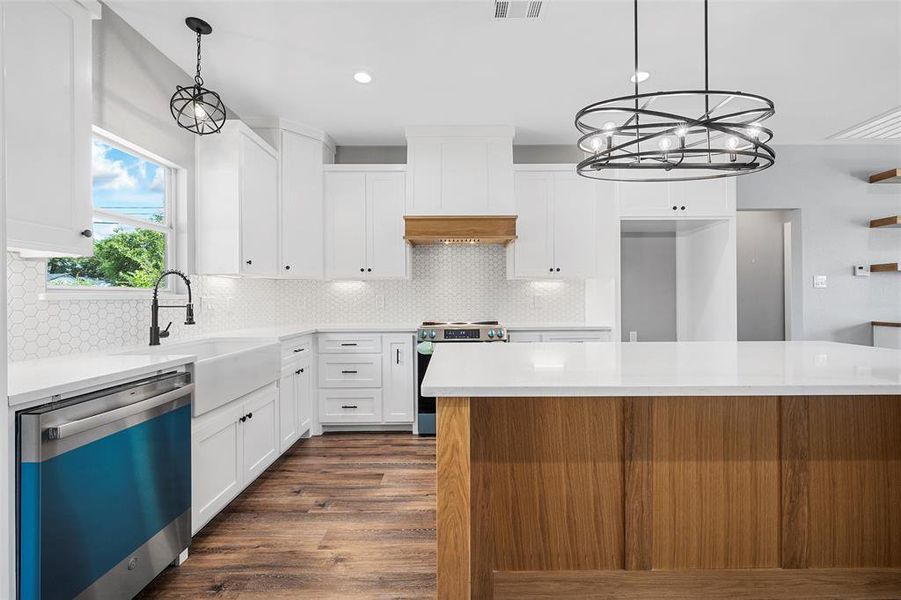 Kitchen with dishwashing machine, stainless steel range with electric cooktop, dark wood-type flooring, light countertops, and recessed lighting
