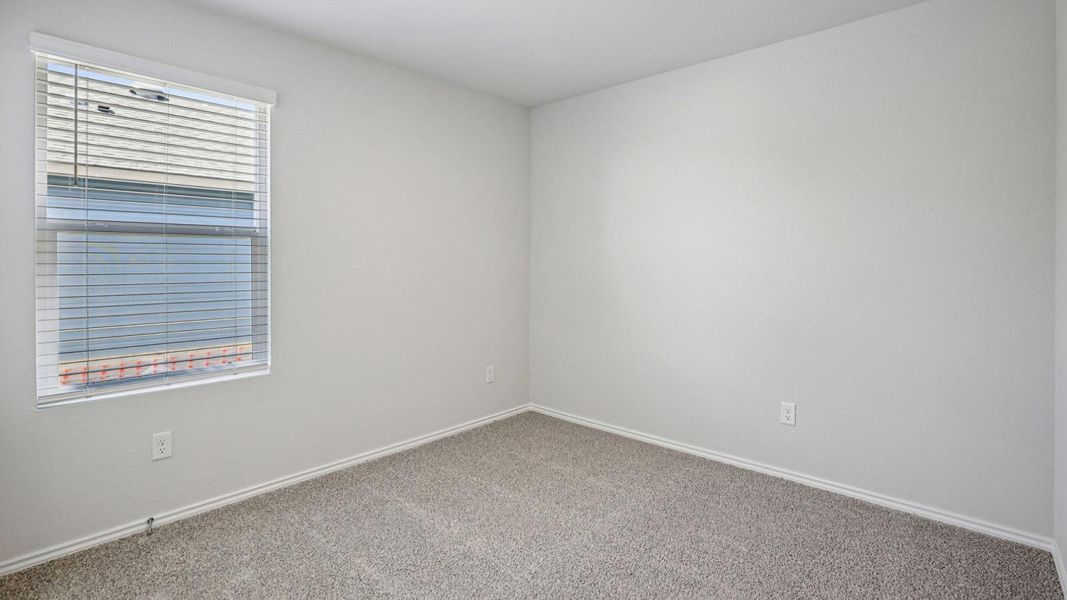 Empty room featuring baseboards and carpet floors