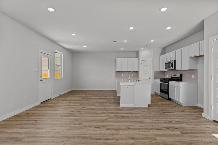 A kitchen with white cabinets.