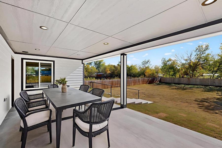 Fenced backyard with outdoor dining space and a patio