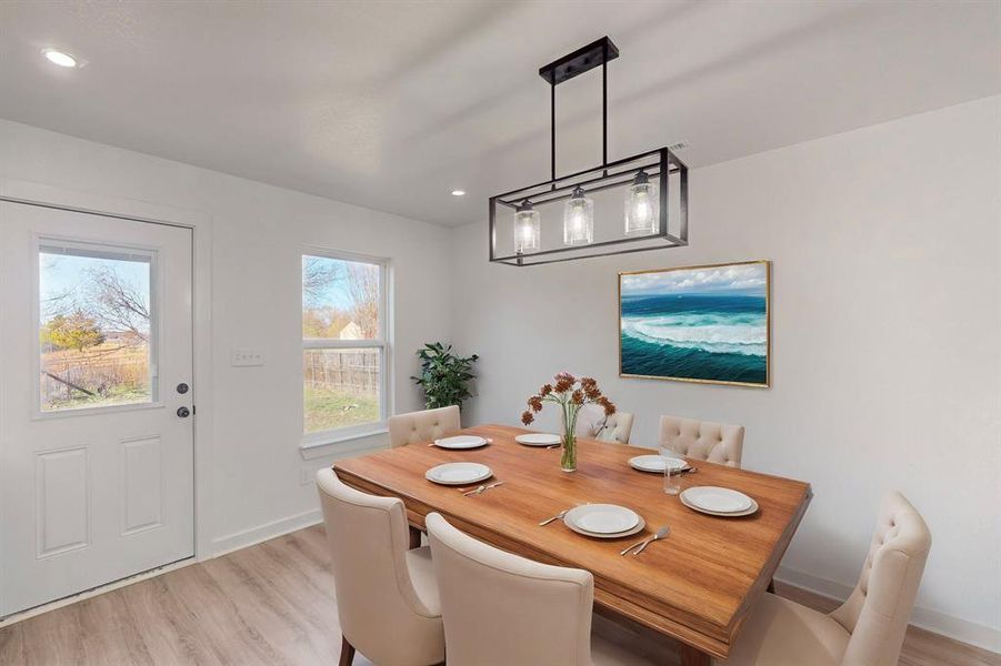 Dining area with light wood-type flooring