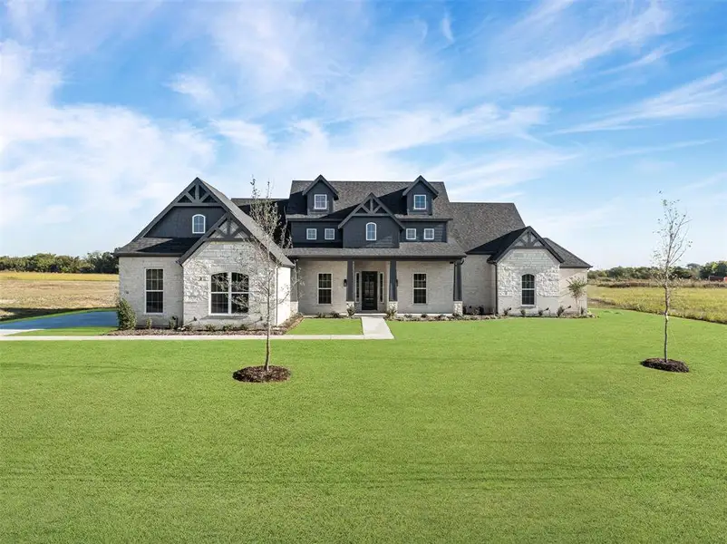 Front exterior of a new home in Waterfall Ranch - 1 Acre Lots, Waxahachie, TX, highlighting curb appeal (Image 1). Front exterior of a new home in Waterfall Ranch - 1 Acre Lots, Waxahachie, TX, highlighting curb appeal (Image 1).