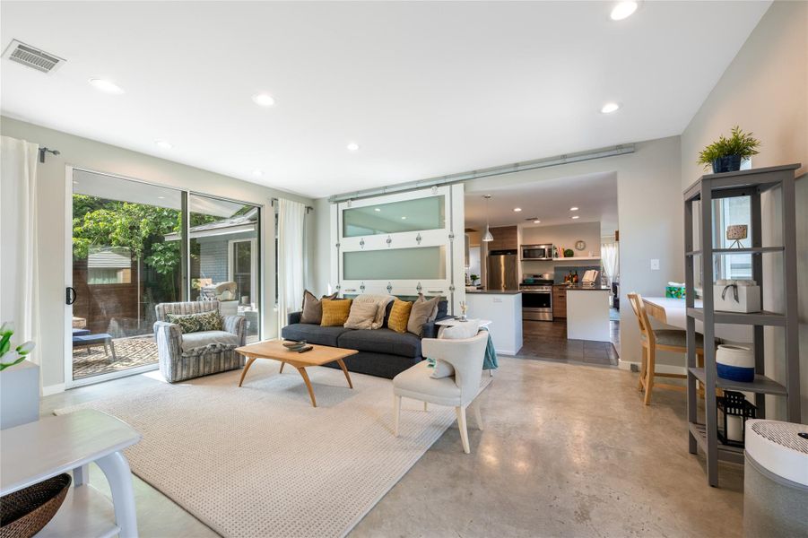 Sliding glass doors open onto a private courtyard, connecting living spaces with the outdoors. Sliding glass doors open onto a private courtyard, connecting living spaces with the outdoors.