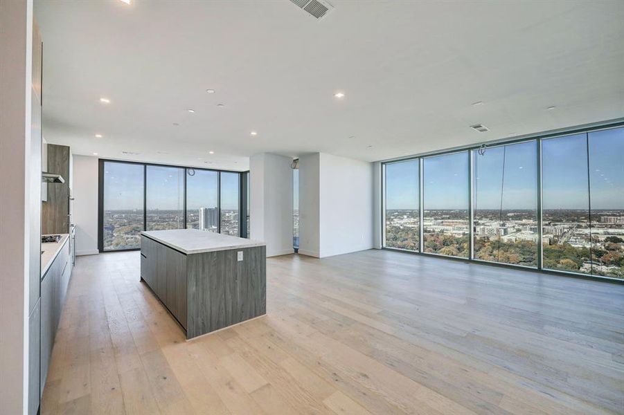 Floor-to-ceiling windows frame the urban panorama, inviting natural light to illuminate the elegant space. Immerse yourself in the vibrant energy of the city, while relishing the comfort and luxury of this captivating living room retreat.