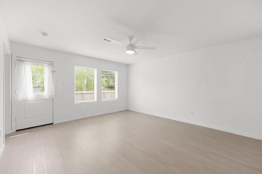 Alternate view highlights the living room’s open footprint, abundant natural light, and generous wall space for flexible furniture arrangements. Alternate view highlights the living room’s open footprint, abundant natural light, and generous wall space for flexible furniture arrangements.