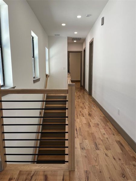 Modern horizontal stair railing upstairs with wood stairs leading toward the first floor. All floors are wood or tile. No carpet. Modern horizontal stair railing upstairs with wood stairs leading toward the first floor. All floors are wood or tile. No carpet.