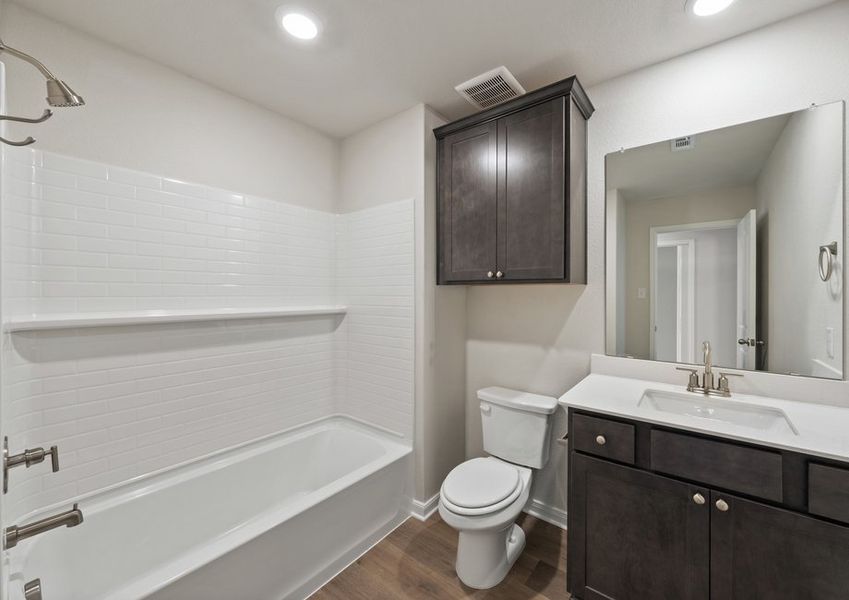 The secondary bathroom has a sprawling vanity and a shower-tub combo. The secondary bathroom has a sprawling vanity and a shower-tub combo.