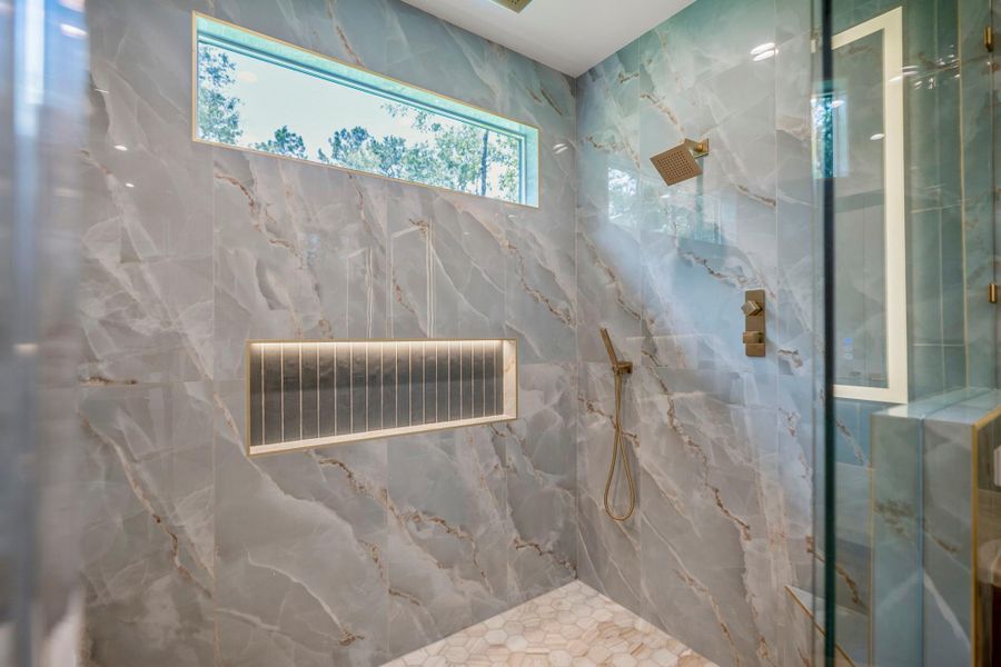 This gorgeous floor to ceiling tile and built-in with accent lighting was curated to show the level of detail that this home has. This gorgeous floor to ceiling tile and built-in with accent lighting was curated to show the level of detail that this home has.