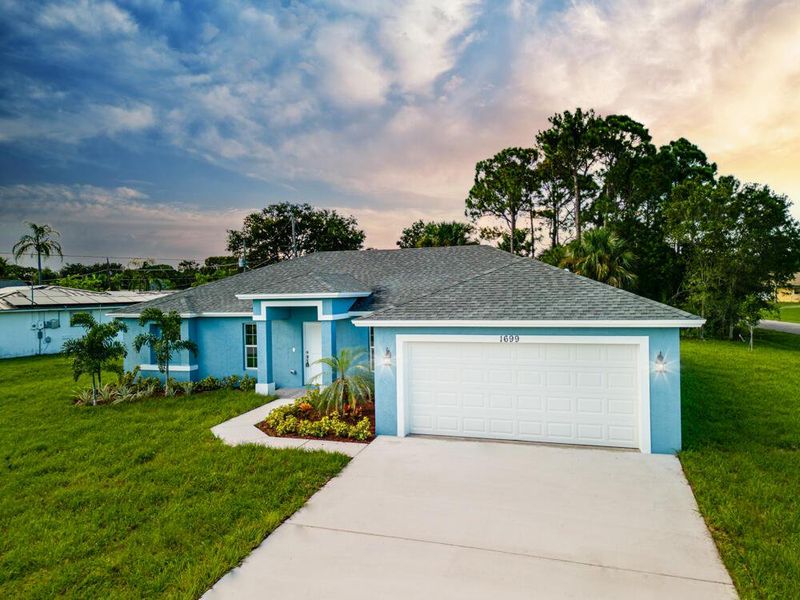 Front exterior of a new home in , Palm Bay, FL, highlighting curb appeal (Image 23).