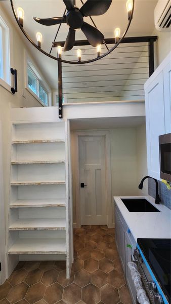 View from living room looking into kitchen and up towards one of the 7' x 7' lofts. View from living room looking into kitchen and up towards one of the 7' x 7' lofts.
