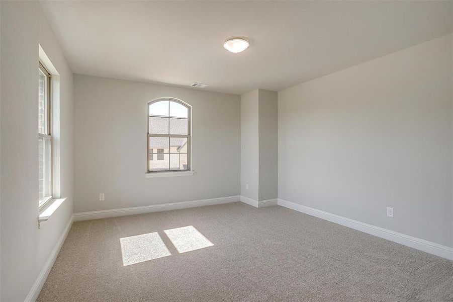 Spare room featuring light carpet and baseboards Spare room featuring light carpet and baseboards