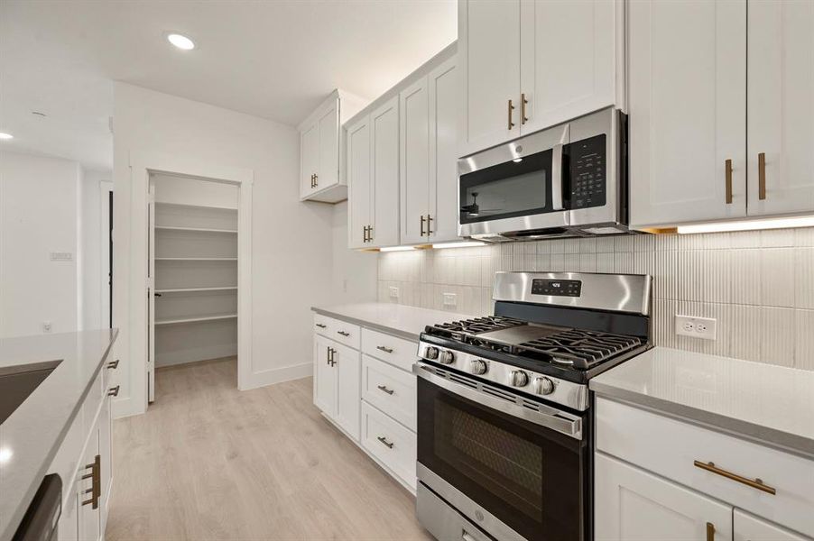 Featuring gorgeous cabinetry, beautiful countertops, designer backsplash, and a dreamy walk in pantry, any chef would be proud to call this fantastic kitchen their own! Featuring gorgeous cabinetry, beautiful countertops, designer backsplash, and a dreamy walk in pantry, any chef would be proud to call this fantastic kitchen their own!