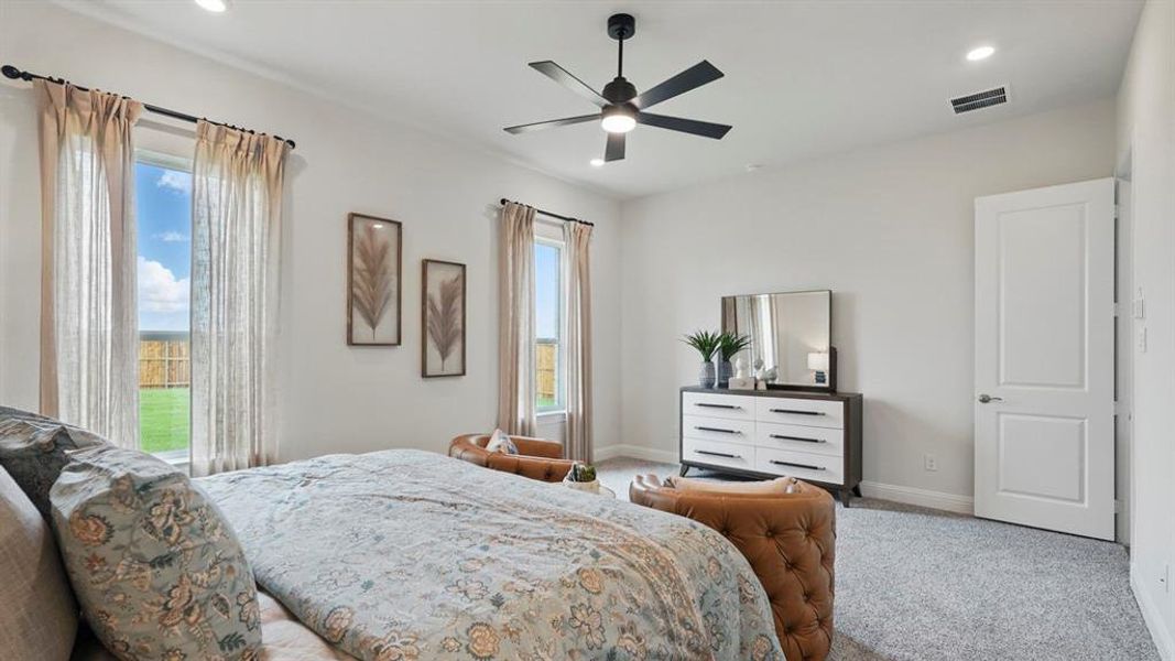Spacious room featuring multiple windows with natural light, recessed lighting, a ceiling fan, and carpet flooring