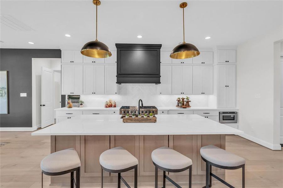 Beautiful chef's kitchen featuring cabinets to the ceiling, a slide-in 48" gas range with double oven, and much more.