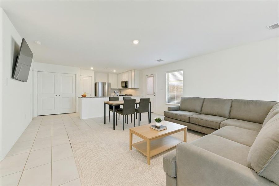 Living room featuring light tile patterned floors and recessed lighting Living room featuring light tile patterned floors and recessed lighting