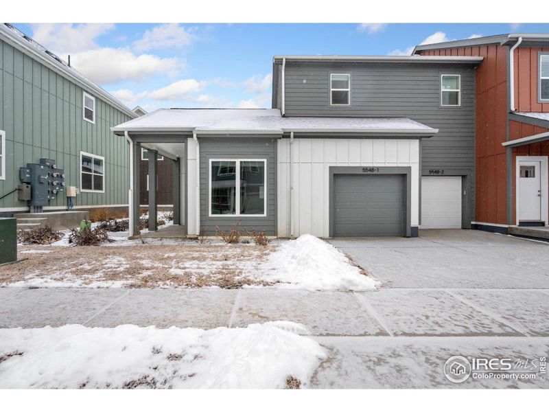 Front of home, with a one car attached garage.