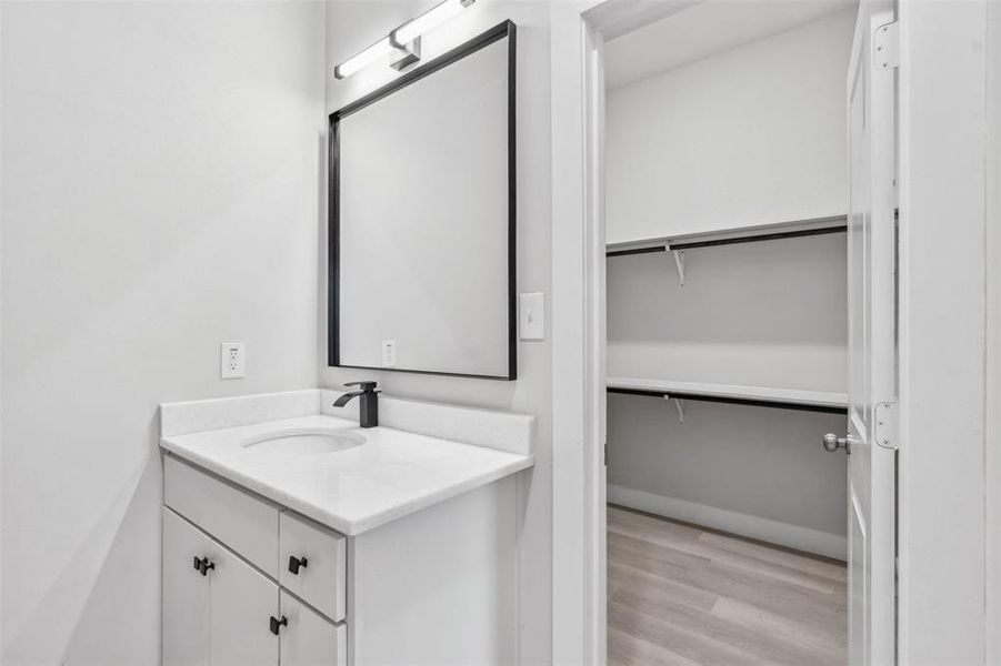 Bathroom with vanity and hardwood / wood-style flooring