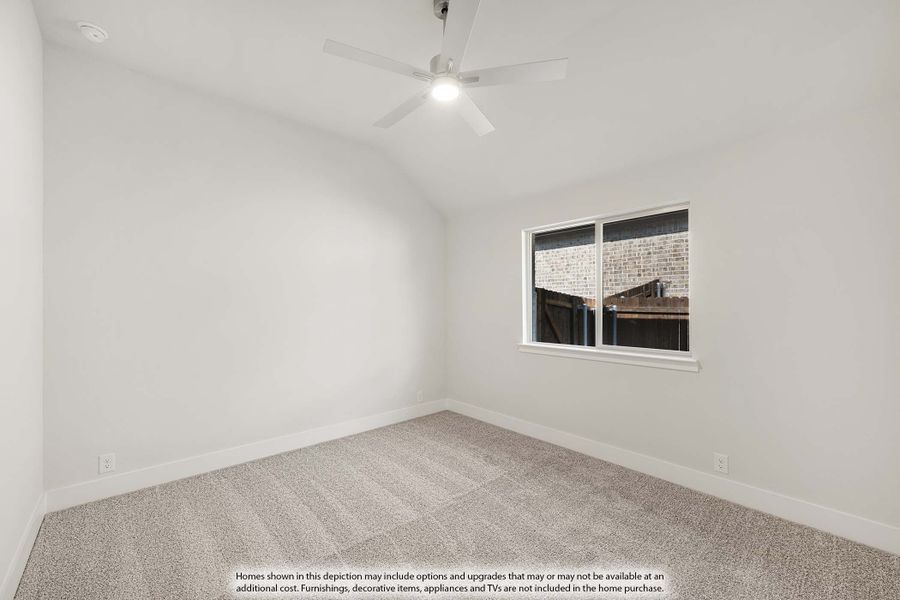 Empty bedroom with vaulted ceiling, ceiling fan, carpet flooring, and a single window Empty bedroom with vaulted ceiling, ceiling fan, carpet flooring, and a single window