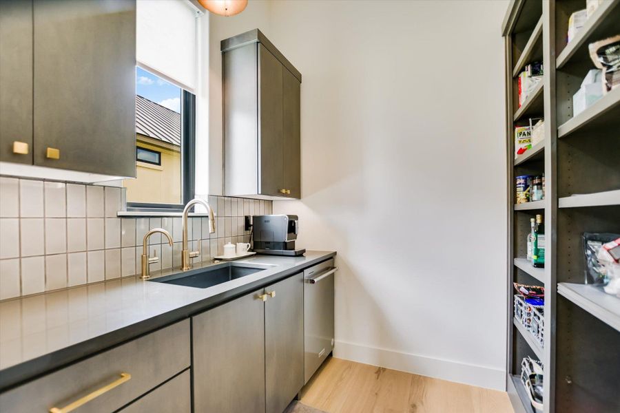 A well-appointed kitchen features a deep sink and ample cabinetry with sleek hardware.