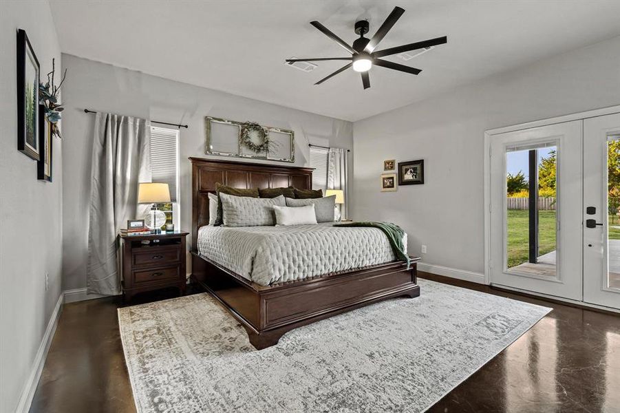 Bedroom with access to exterior, multiple windows, ceiling fan, and french doors Bedroom with access to exterior, multiple windows, ceiling fan, and french doors