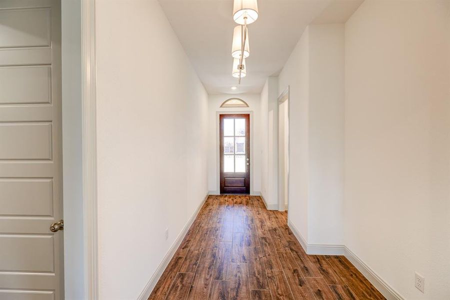 Entryway with wood finished floors and baseboards Entryway with wood finished floors and baseboards