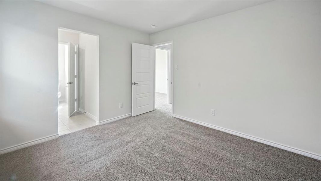 Unfurnished bedroom featuring light carpet and baseboards Unfurnished bedroom featuring light carpet and baseboards