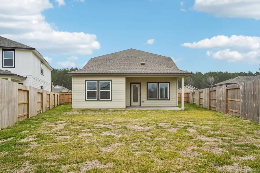 Exterior details and patio area of a home in Landing Meadows - Traditional Series, New Caney (Image 4).