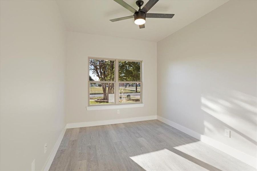 Unfurnished room featuring light hardwood / wood-style flooring and ceiling fan