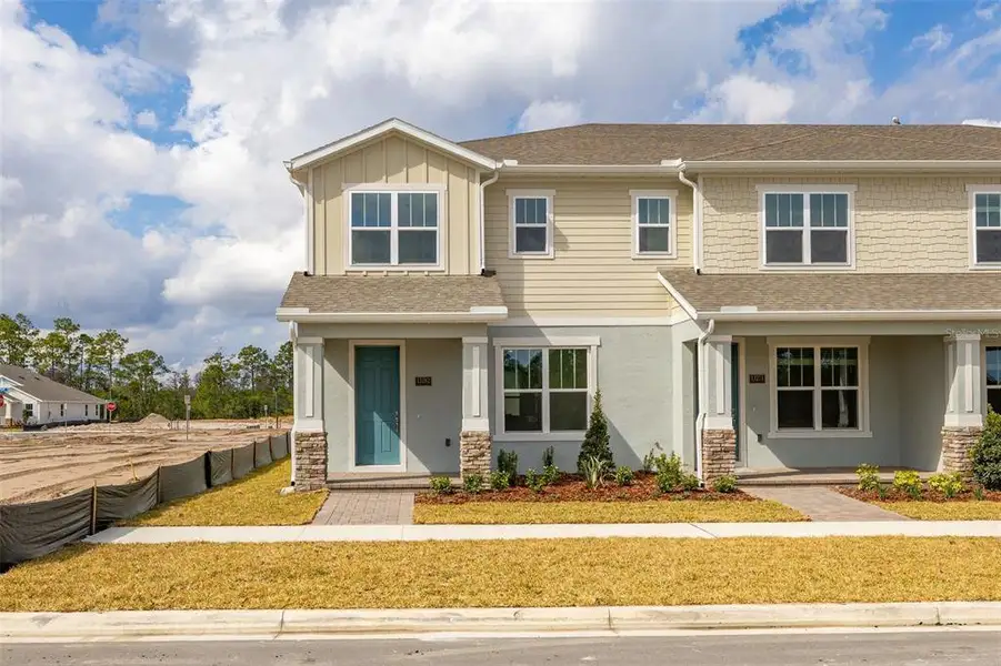 Front exterior of a new home in Serenade at Ovation, Winter Garden, FL, highlighting curb appeal (Image 2). Front exterior of a new home in Serenade at Ovation, Winter Garden, FL, highlighting curb appeal (Image 2).