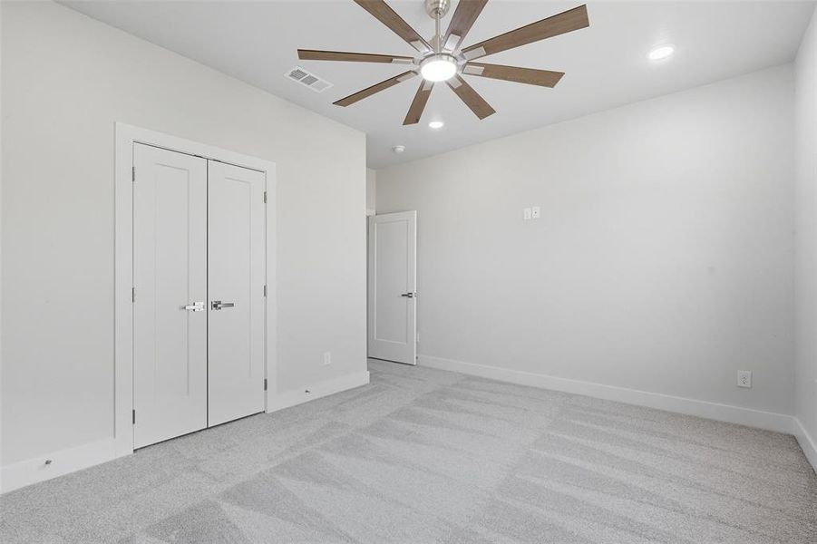Unfurnished bedroom with light carpet, recessed lighting, a ceiling fan, and a closet Unfurnished bedroom with light carpet, recessed lighting, a ceiling fan, and a closet