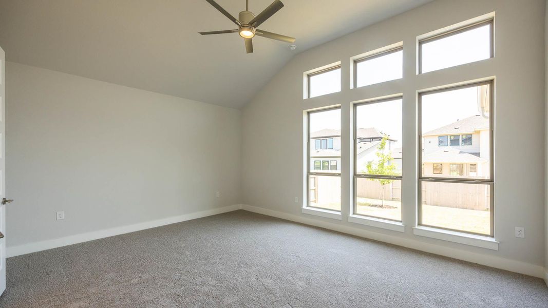 Additional living space featuring carpet flooring, a ceiling fan, vaulted ceiling, and baseboards Additional living space featuring carpet flooring, a ceiling fan, vaulted ceiling, and baseboards