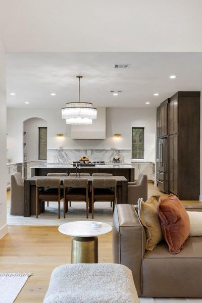 An open-concept living space integrates a well-appointed kitchen with a stylish dining area and adjacent lounging zone. An open-concept living space integrates a well-appointed kitchen with a stylish dining area and adjacent lounging zone.