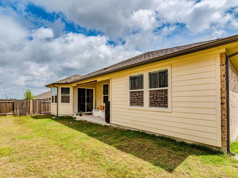 A spacious backyard with a patio perfect for outdoor enjoyment, enclosed by a privacy fence & double gated feature.