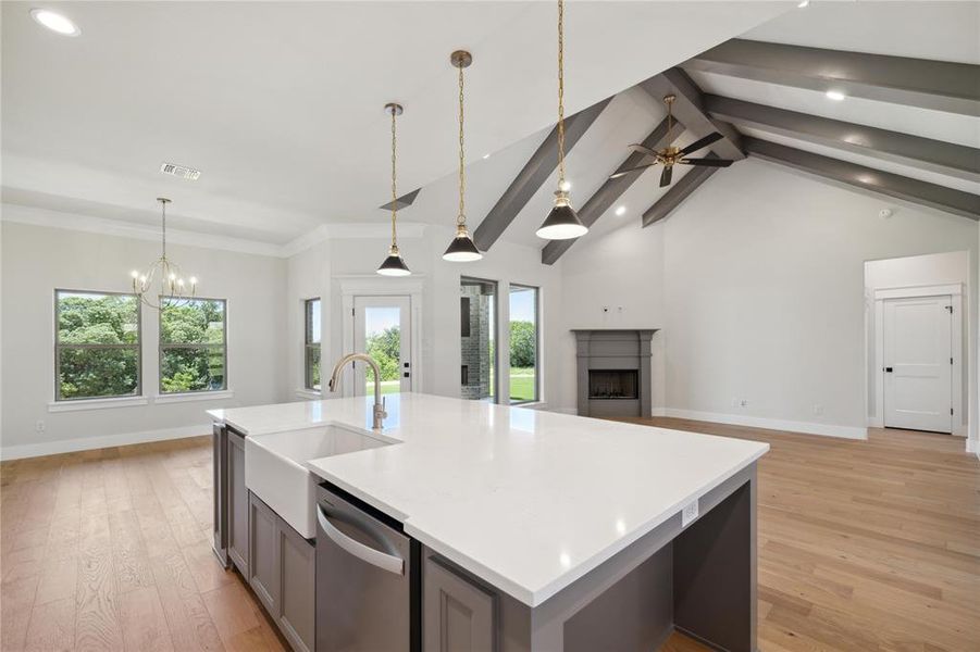 Kitchen featuring sink, stainless steel dishwasher, a wealth of natural light, and light hardwood / wood-style flooring